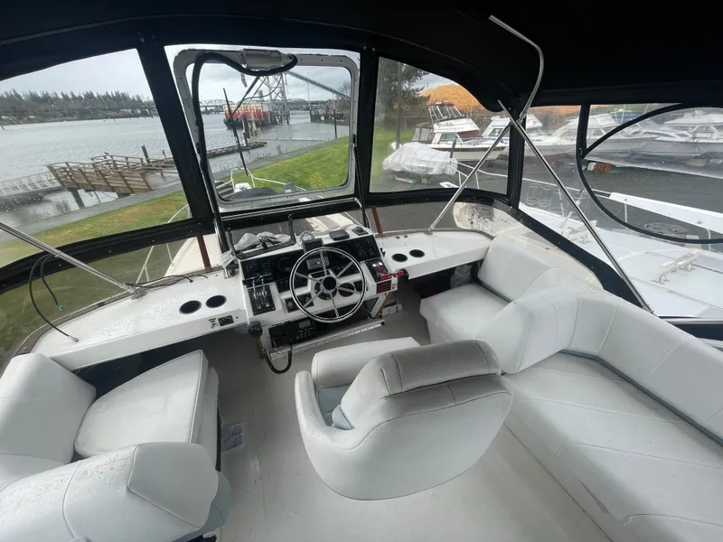 Slide: The Image of Interior of a 1992 Bayliner 38 Motoryacht with white seating. - 8