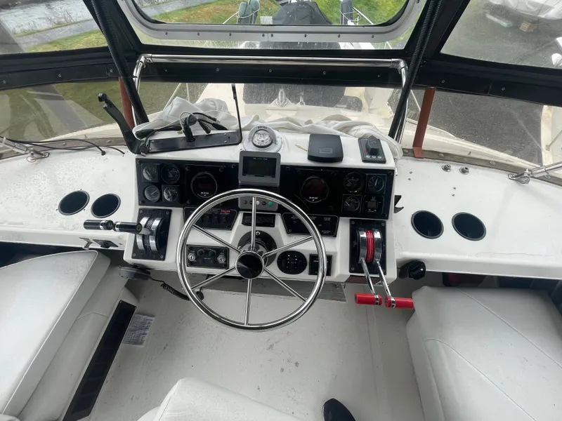 Slide: The Image of 1992 Bayliner 38 Motoryacht cockpit with steering wheel and instruments. - 9