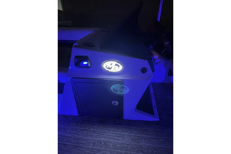Slide: The Image of 2026 Montego Bay 8522 BR DLX boat console illuminated in blue light. - 14