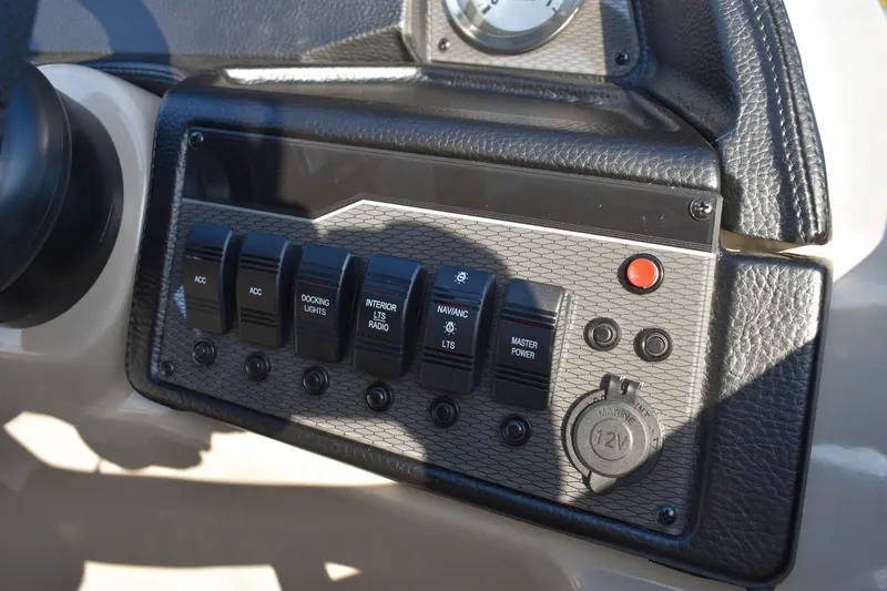 Slide: The Image of Control panel of 2026 Montego Bay 8522 BR DLX boat with switches and 12V outlet. - 17