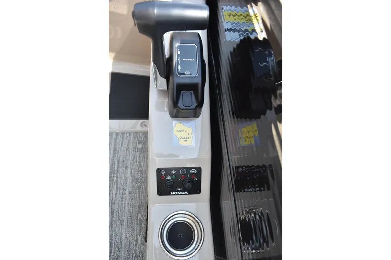Slide: The Image of Control panel of 2026 Montego Bay 8522 BR DLX boat with Honda throttle and cup holder. - 18