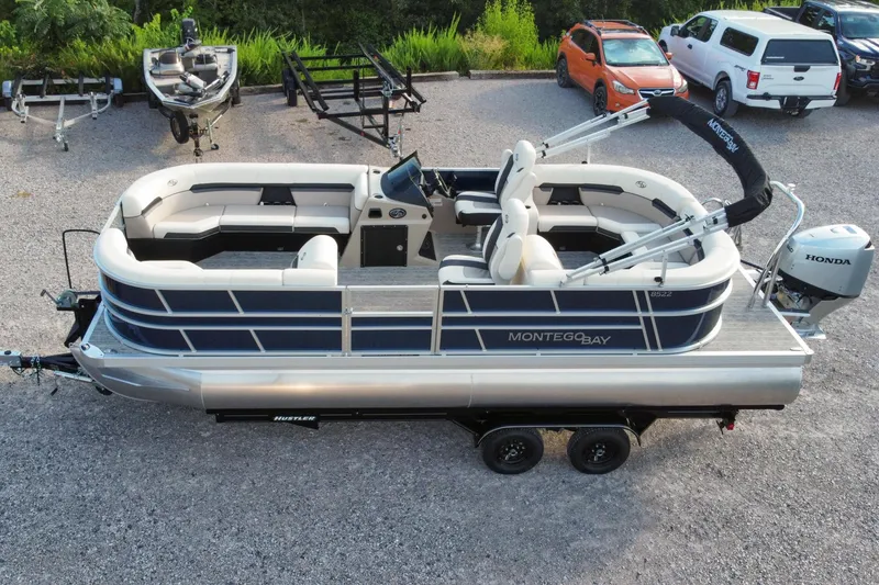 Slide: The Image of 2026 Montego Bay 8522 BR DLX pontoon boat with Honda motor in parking lot. - 4