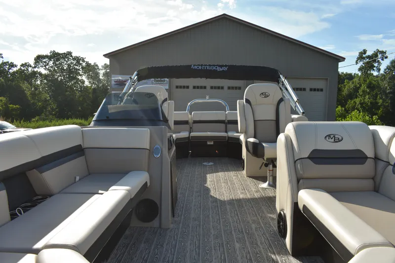 Slide: The Image of 2026 Montego Bay 8522 BR DLX pontoon boat with luxurious seating and sleek design. - 8