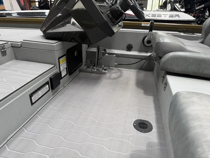 Slide: The Image of Interior of a 2024 Avid 18XC boat with gray seating. - 12