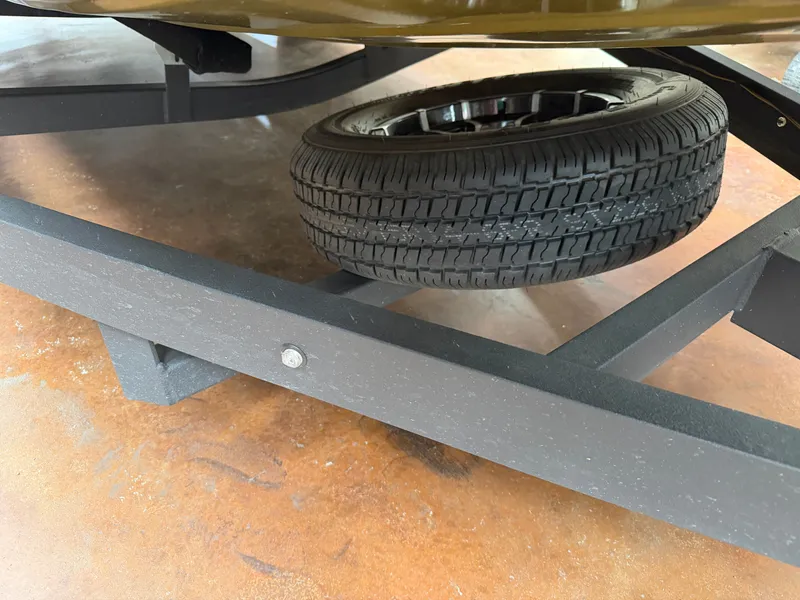 Slide: The Image of Spare tire under Avid 18XC trailer, 2024 model. - 23
