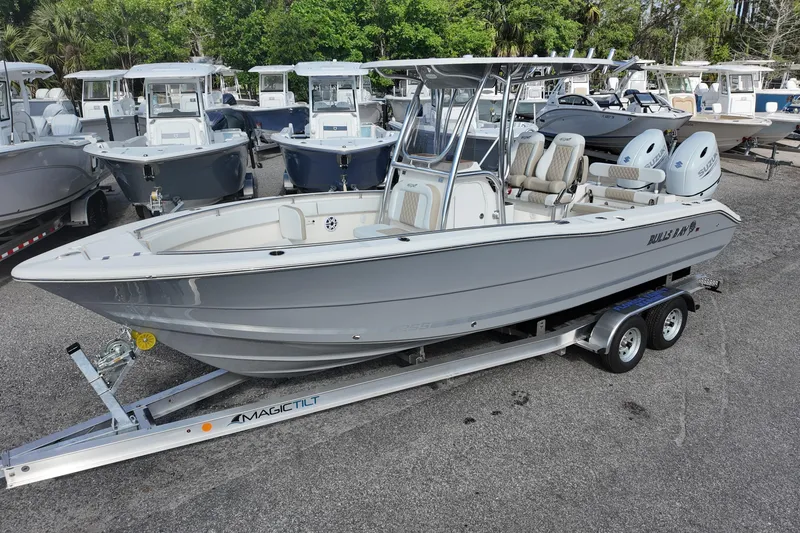 The Image of 2026 Bulls Bay 255 Center Console boat on trailer, surrounded by other boats. - 0