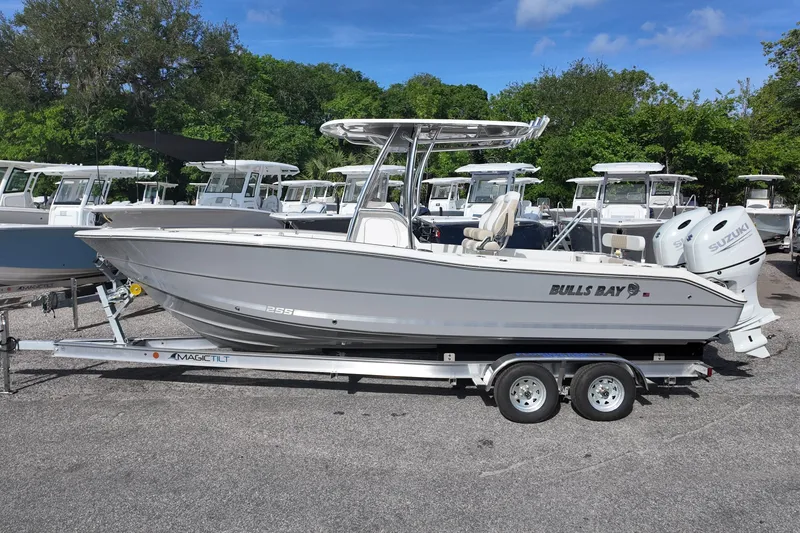 Slide: The Image of 2026 Bulls Bay 255 Center Console boat on trailer, parked outdoors. - 12