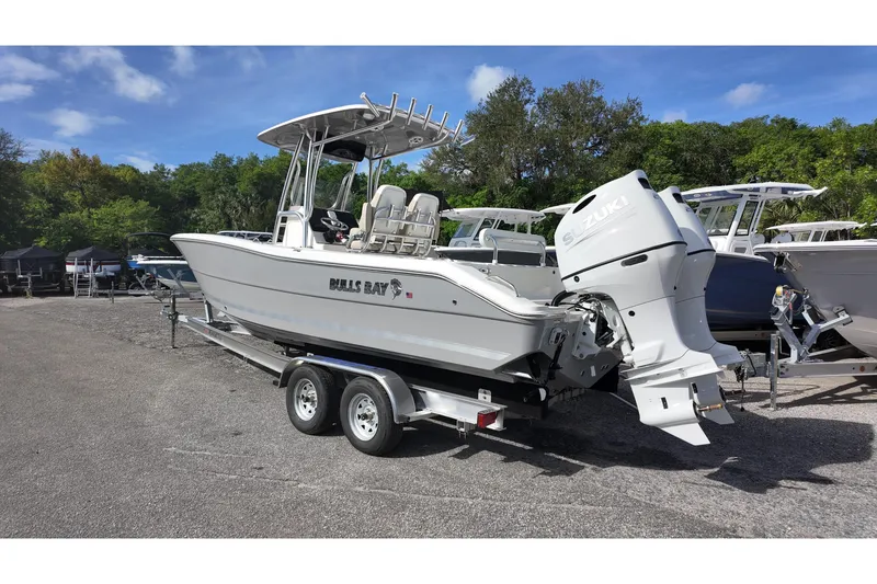 Slide: The Image of 2026 Bulls Bay 255 Center Console boat on trailer with Suzuki outboard motor. - 13