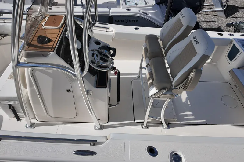Slide: The Image of 2026 Bulls Bay 255 Center Console boat interior with dual seats and steering console. - 15