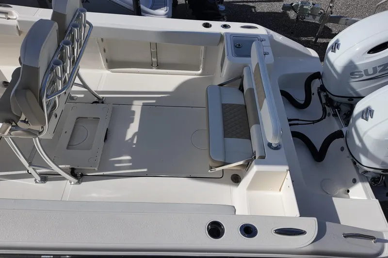 Slide: The Image of 2026 Bulls Bay 255 Center Console boat interior with seating and dual Suzuki engines. - 16