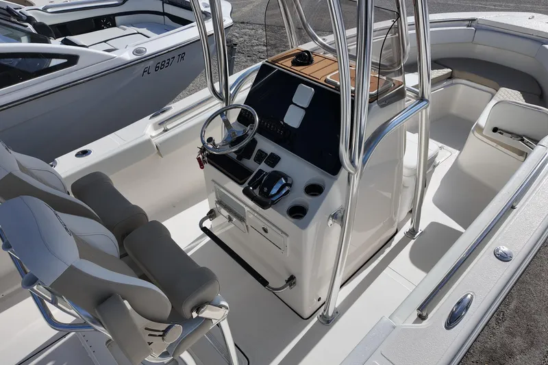 Slide: The Image of 2026 Bulls Bay 255 Center Console boat interior with steering wheel and seating. - 2
