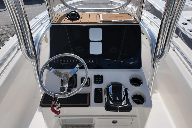 Slide: The Image of 2026 Bulls Bay 255 Center Console boat dashboard with steering wheel and controls. - 3