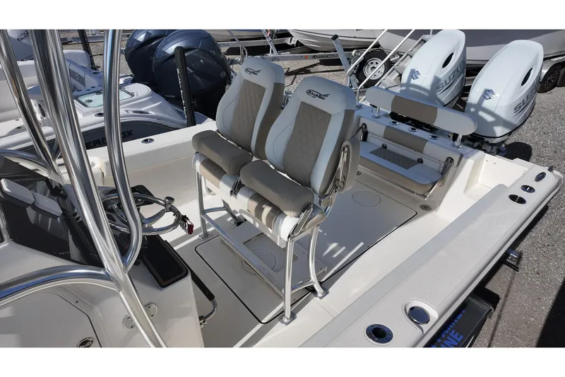 Slide: The Image of 2026 Bulls Bay 255 Center Console boat interior with dual seats and twin engines. - 9