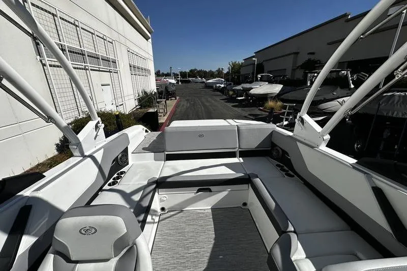 Slide: The Image of 2025 Cobalt CS23 boat interior with white seating and modern design. - 5
