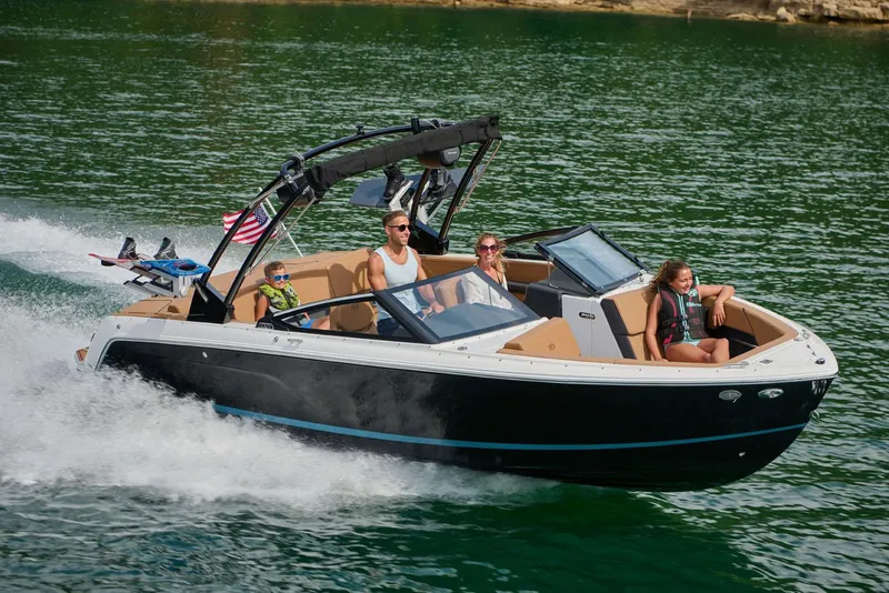 Slide: The Image of Manufacturer Provided Image: 2025 Cobalt CS23 boat cruising on a lake with passengers enjoying the ride. - 8