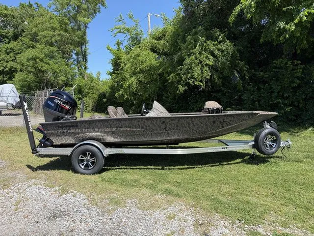 The Image of 2026 Xpress Hyper-Lift Bass H18 boat on trailer outdoors. - 1