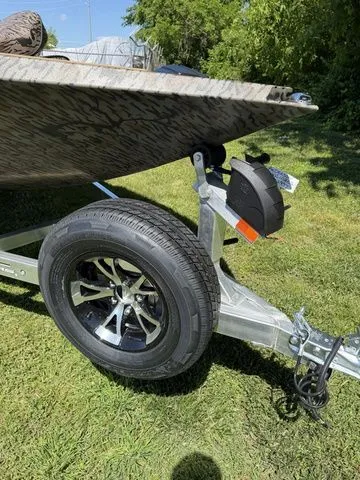 Slide: The Image of 2026 Xpress Hyper-Lift Bass H18 boat trailer on grass. - 5