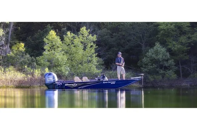 The Image of Angler on a G3 Sportsman 1710 boat fishing on a serene lake. - 1