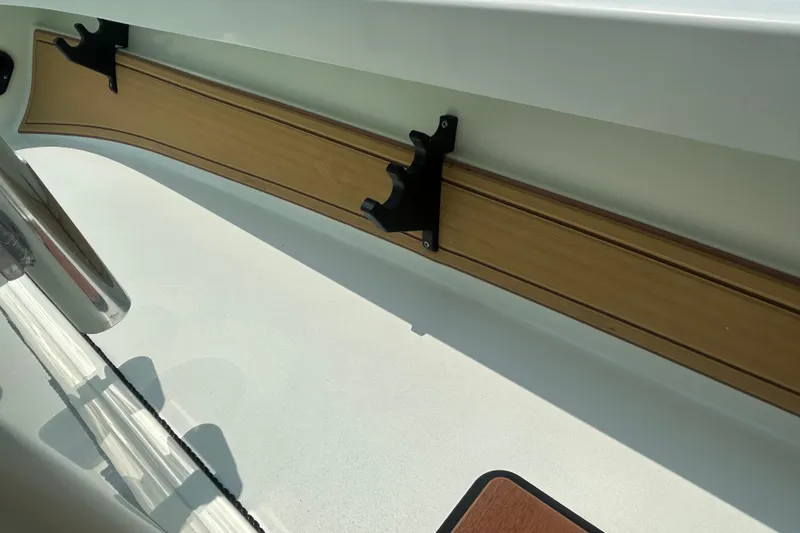 Slide: The Image of 2019 Beavertail Skiffs Mosquito interior detail with rod holder and wooden trim. - 10