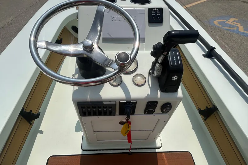 Slide: The Image of 2019 Beavertail Skiffs Mosquito boat console with steering wheel and controls. - 11