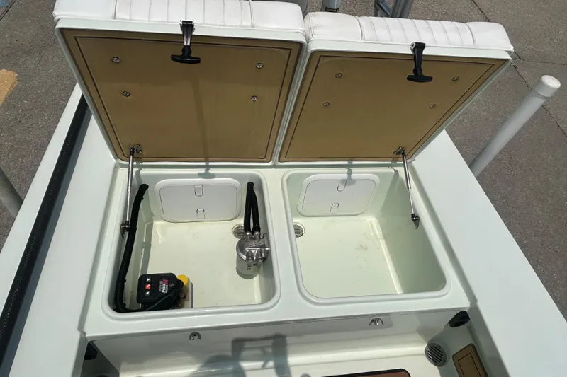 Slide: The Image of 2019 Beavertail Skiffs Mosquito storage compartments with open lids, showcasing interior features. - 14