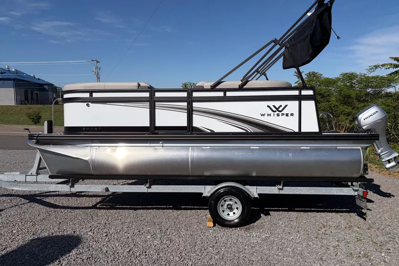 Slide: The Image of 2026 Whisper S17 pontoon boat on trailer with Honda outboard motor. - 2