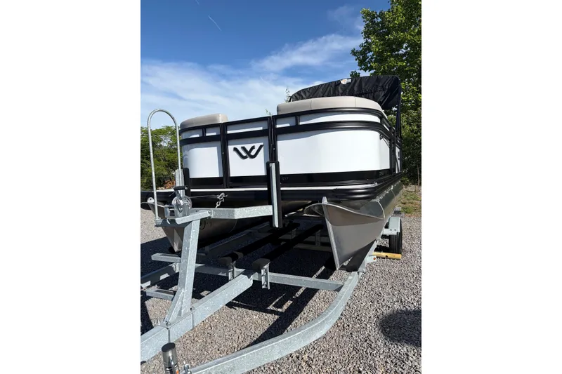 Slide: The Image of 2026 Whisper S17 pontoon boat on trailer, parked outdoors under clear sky. - 4