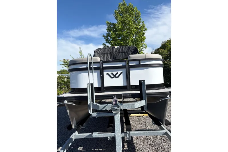 Slide: The Image of 2026 Whisper S17 boat on trailer, parked outdoors under clear blue sky. - 5