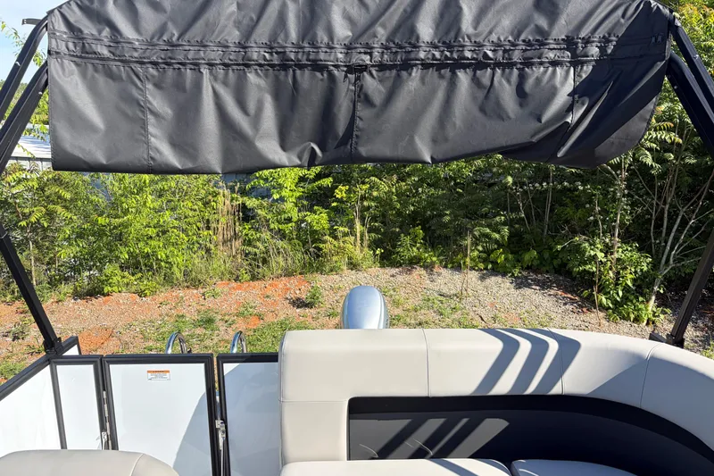 Slide: The Image of Pontoon boat interior with canopy, Whisper S17 model, 2026, surrounded by greenery. - 8