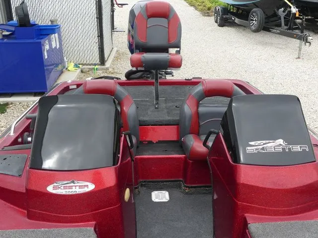 Slide: The Image of Red Skeeter ZX202 boat, 2000 model, featuring dual seats and console. - 23