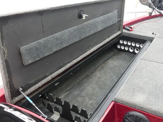 Slide: The Image of Skeeter ZX202 2000 boat with open storage compartment and rod holders. - 24