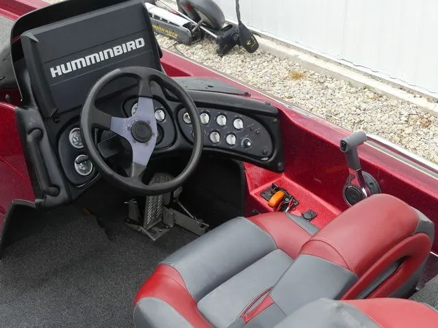 Slide: The Image of Interior of a 2000 Skeeter ZX202 boat with steering and seats. - 29
