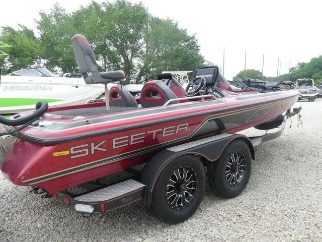 Slide: The Image of Red 2000 Skeeter ZX202 bass boat on trailer, side view. - 4