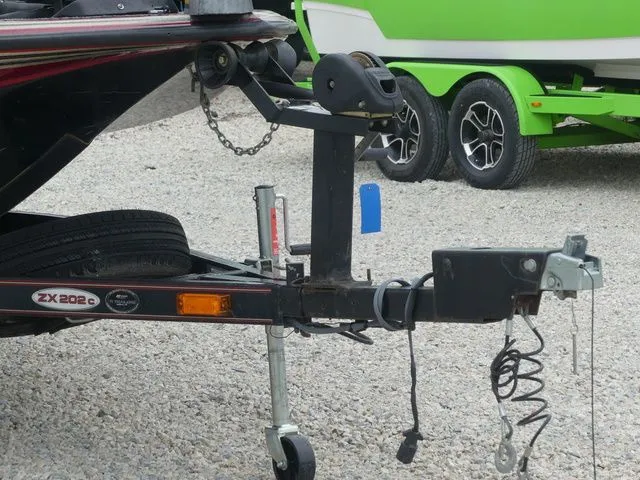 Slide: The Image of Trailer of a 2000 Skeeter ZX202 boat on gravel surface. - 9