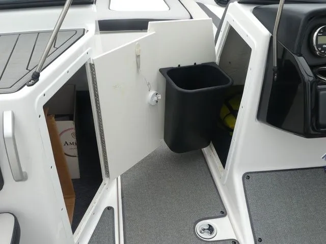 Slide: The Image of Interior of a 2019 Yamaha AR195 boat with storage compartment. - 42