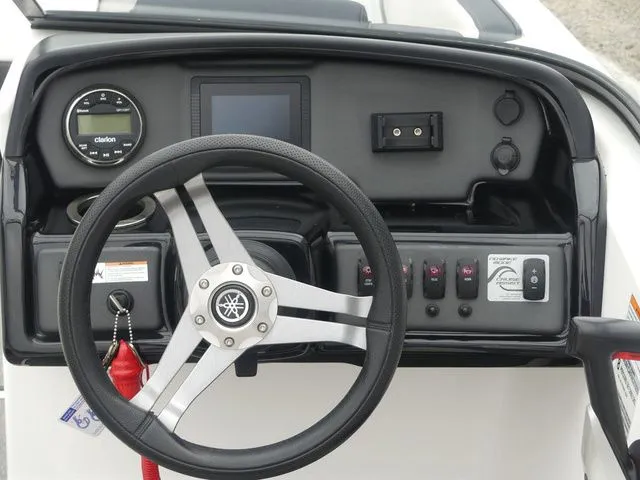 Slide: The Image of Dashboard of a 2019 Yamaha AR195 boat with steering wheel and controls. - 48