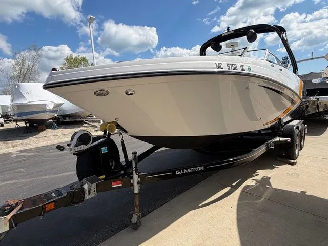Slide: The Image of 2017 Glastron GTS245 boat on trailer under blue sky. - 10