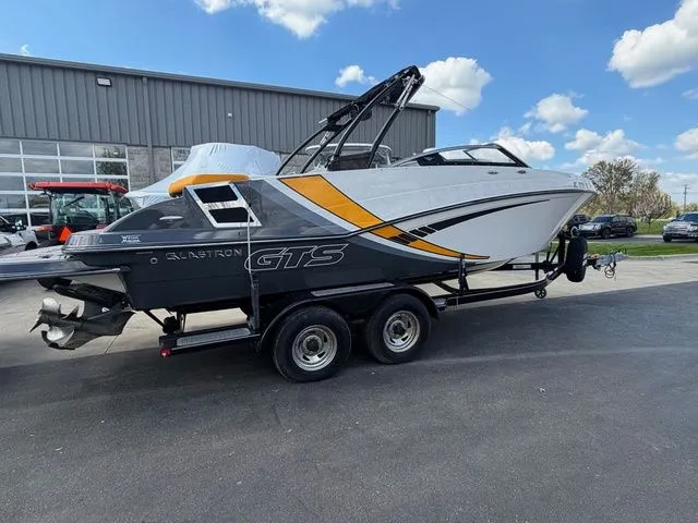 Slide: The Image of 2017 Glastron GTS245 boat on trailer in front of building. - 8