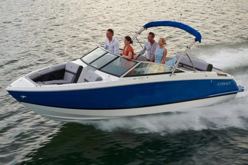 Slide: The Image of Manufacturer Provided Image: 2025 Cobalt R4 boat cruising on water with four passengers, blue and white design. - 9