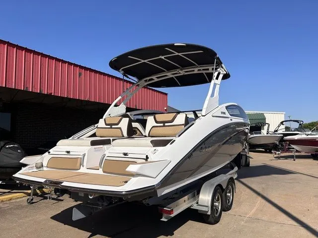 Slide: The Image of 2021 Yamaha Boats 275SE on trailer, modern design, blue sky. - 10