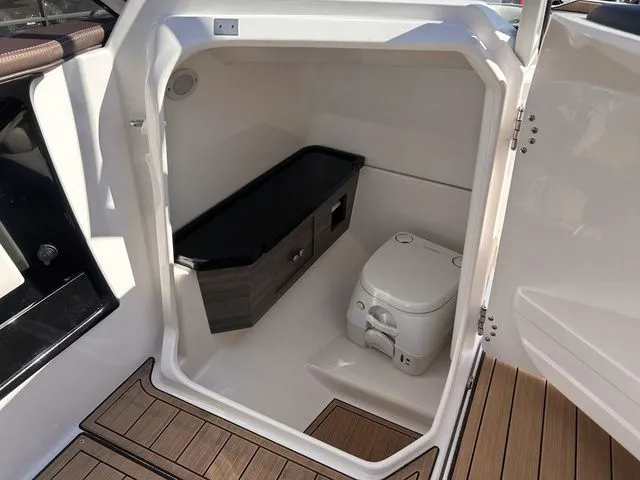 Slide: The Image of Interior of 2021 Yamaha Boats 275SE featuring toilet and storage. - 34