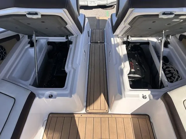 Slide: The Image of 2021 Yamaha Boats 275SE with open storage compartments and wooden flooring. - 36