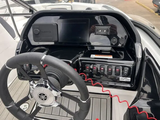 Slide: The Image of 2024 Yamaha Boats 195S dashboard with steering wheel and controls. - 13