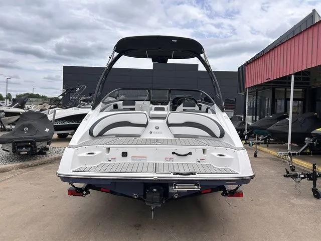Slide: The Image of Rear view of 2024 Yamaha Boats 195S on a parking lot. - 5