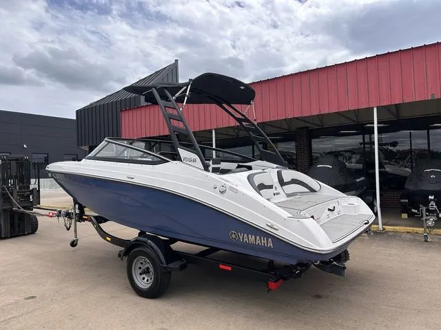 Slide: The Image of 2024 Yamaha Boats 195S on trailer in front of building. - 7