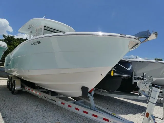 The Image of 2018 Robalo R302 Center Console on trailer, side view. - 1