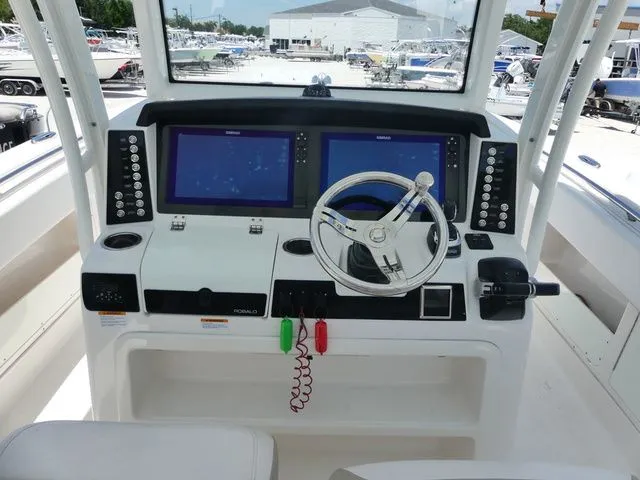 Slide: The Image of 2018 Robalo R302 Center Console helm with modern electronics. - 10