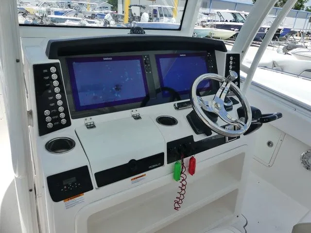 Slide: The Image of 2018 Robalo R302 Center Console helm with dual screens. - 11
