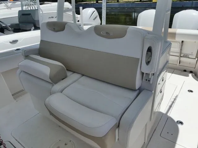 Slide: The Image of 2018 Robalo R302 Center Console seating area in white and beige. - 12