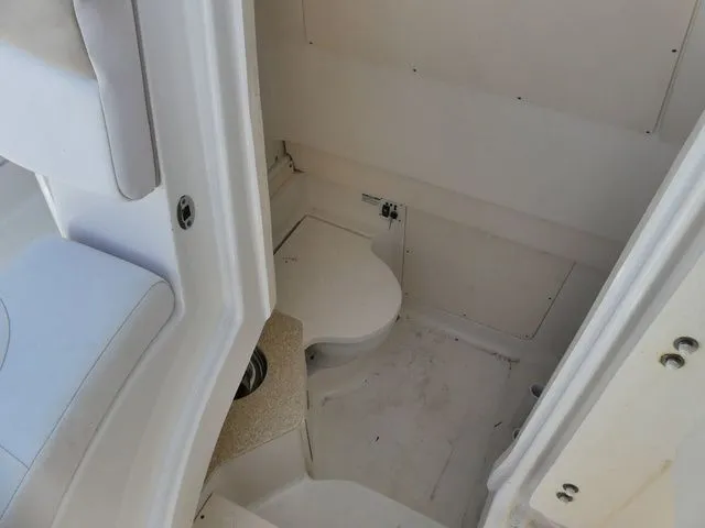 Slide: The Image of Interior of a 2018 Robalo R302 Center Console with toilet. - 18